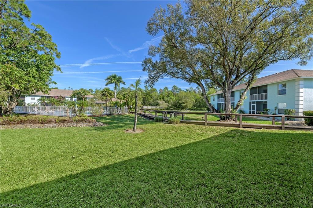 5737 Whitaker Road, Unit C103 Naples, FL 34112 - Photo 22 of 22 a view of a park with large trees