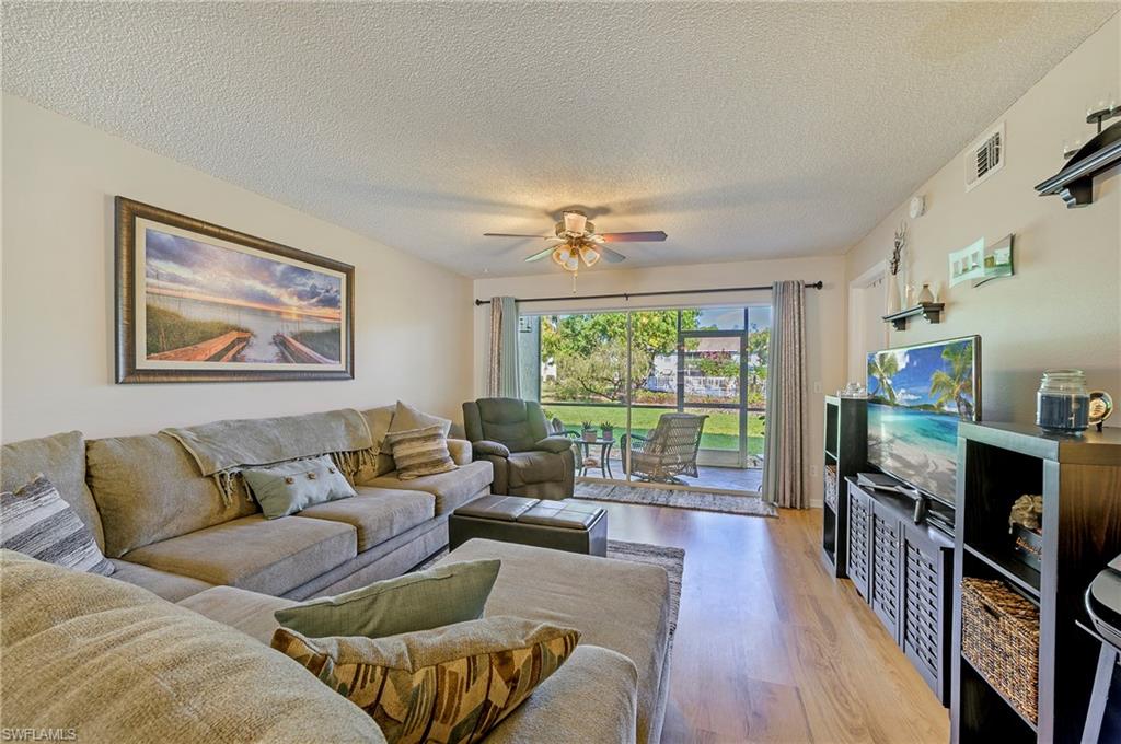 5737 Whitaker Road, Unit C103 Naples, FL 34112 - Photo 3 of 22 a living room with furniture and a flat screen tv