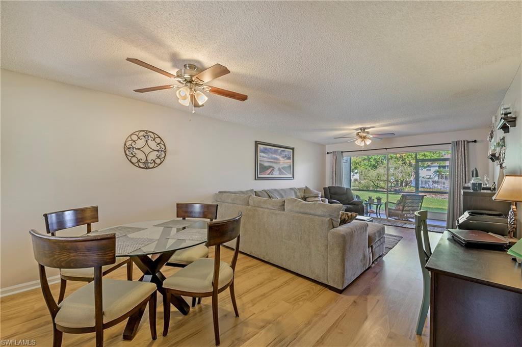 5737 Whitaker Road, Unit C103 Naples, FL 34112 - Photo 5 of 22 a living room with furniture a table and a large window