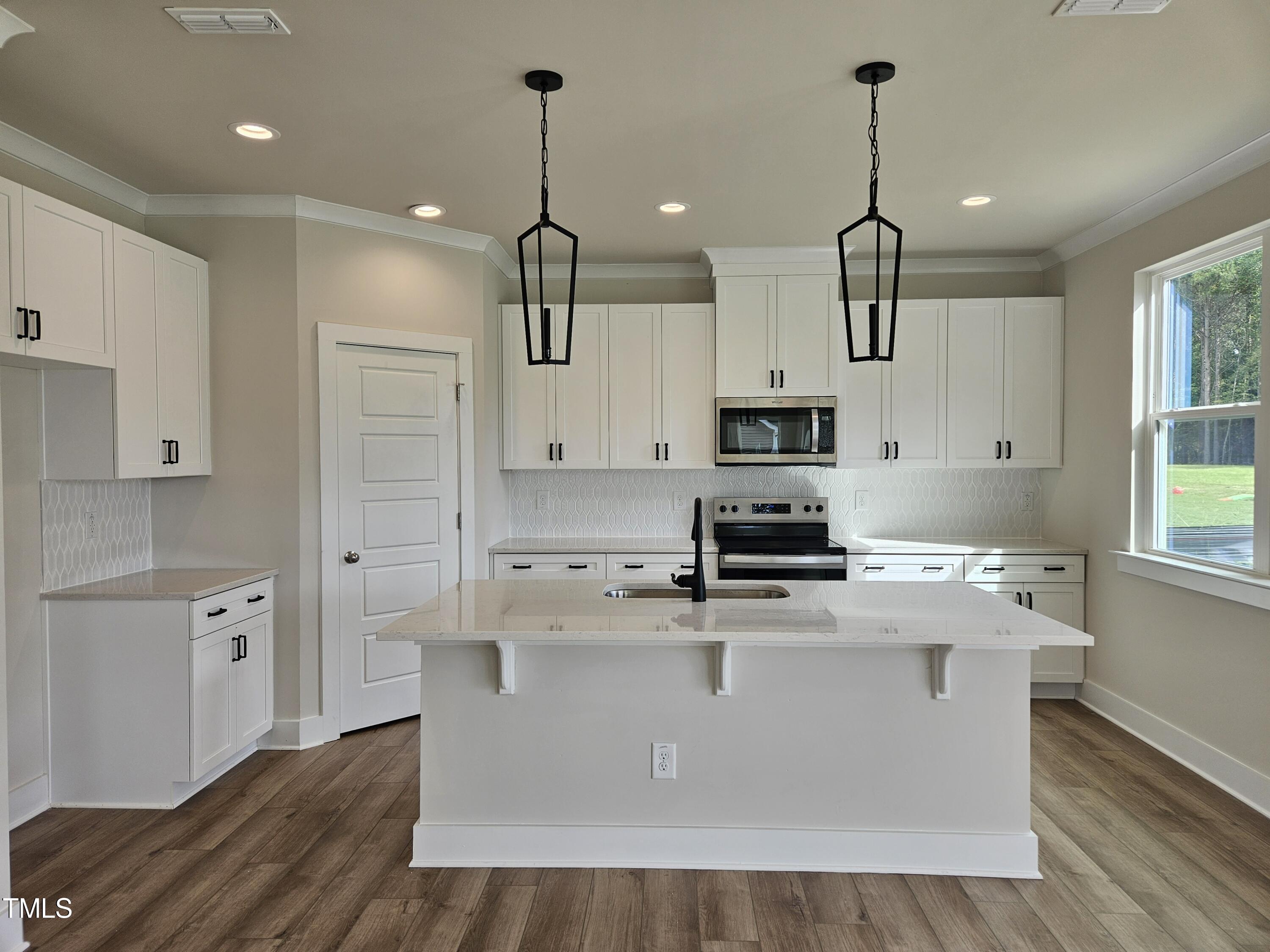 144 Gin Br Road Wendell, NC 27591 - Photo 4 of 18 a kitchen with stainless steel appliances granite countertop a sink a stove and a wooden floors
