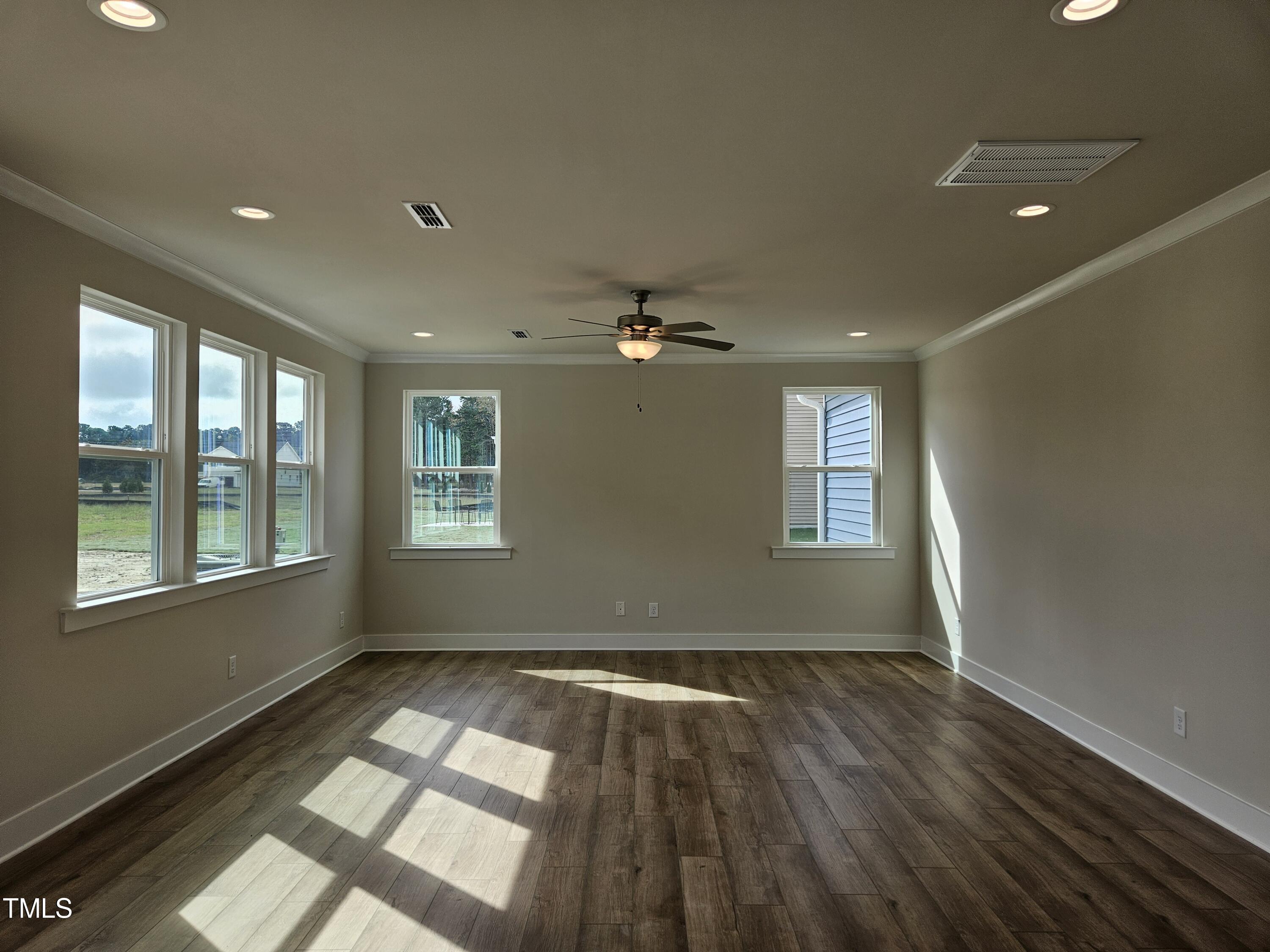 144 Gin Br Road Wendell, NC 27591 - Photo 6 of 18 a view of empty room with wooden floor and fan