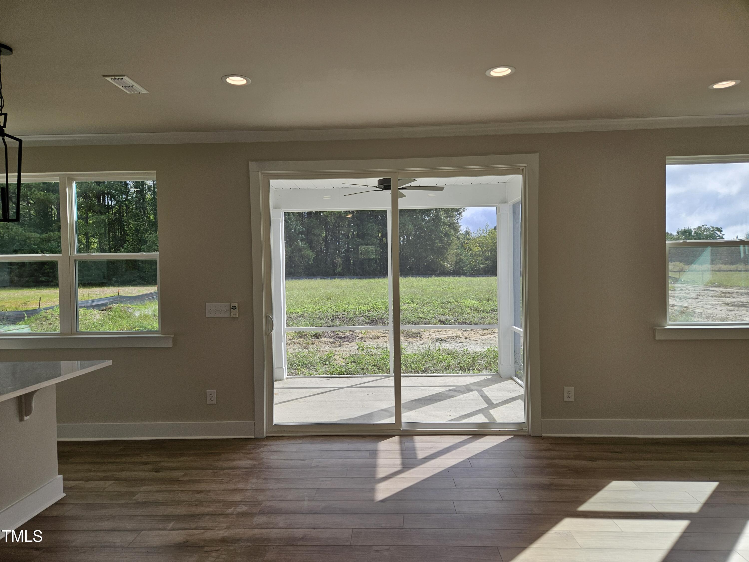 144 Gin Br Road Wendell, NC 27591 - Photo 7 of 18 a view of an empty room with wooden floor and windows