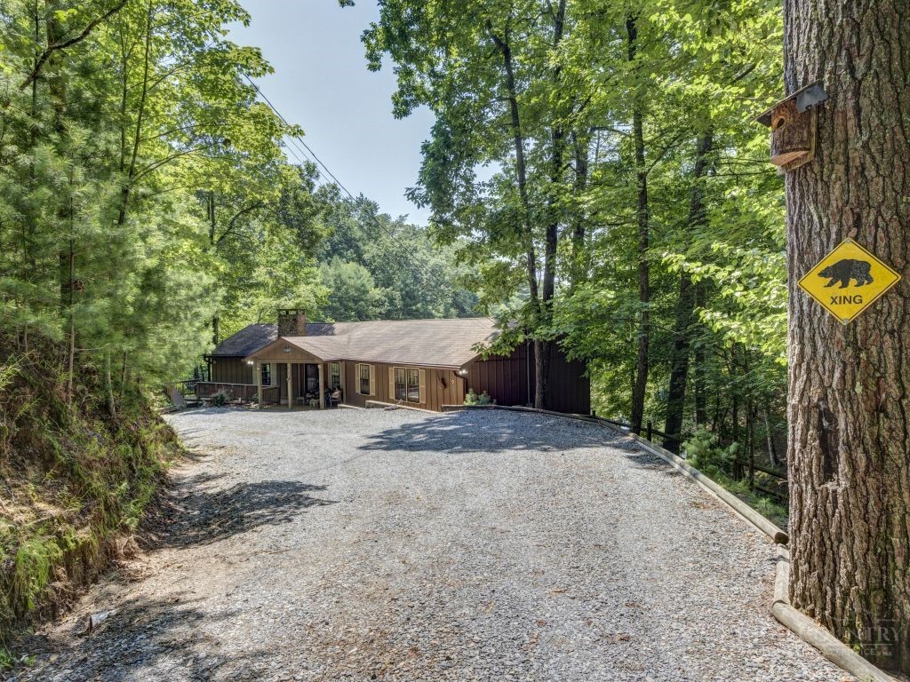 265 Trout Lake Road Deep Gap, NC 28618 - Photo 34 of 50 a view of a house with large trees and wooden fence