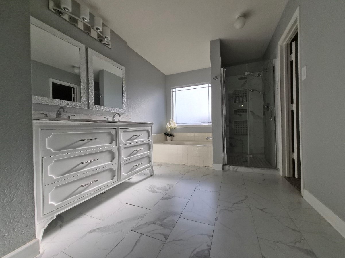16903 Ridgemeadow Court Houston, TX 77083 - Photo 13 of 13 Recently renovated primary bath with modern tile flooring, vanity, and stand-up shower.