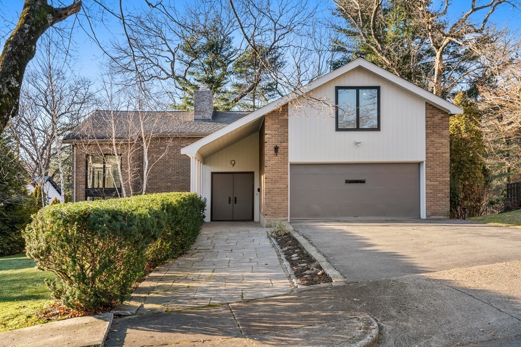 9 Newbrook Circle Newton, MA 02467 - Photo 1 of 28 a front view of a house with garden