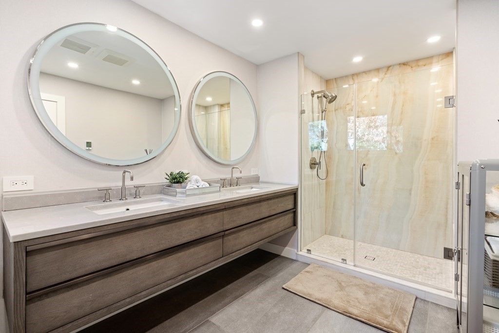 9 Newbrook Circle Newton, MA 02467 - Photo 15 of 28 a bathroom with a double vanity sink mirror and shower
