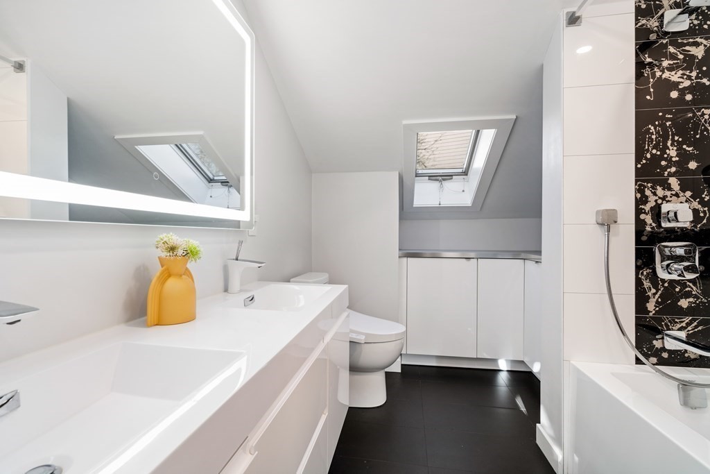 9 Newbrook Circle Newton, MA 02467 - Photo 19 of 28 a bathroom with a sink a toilet and mirror