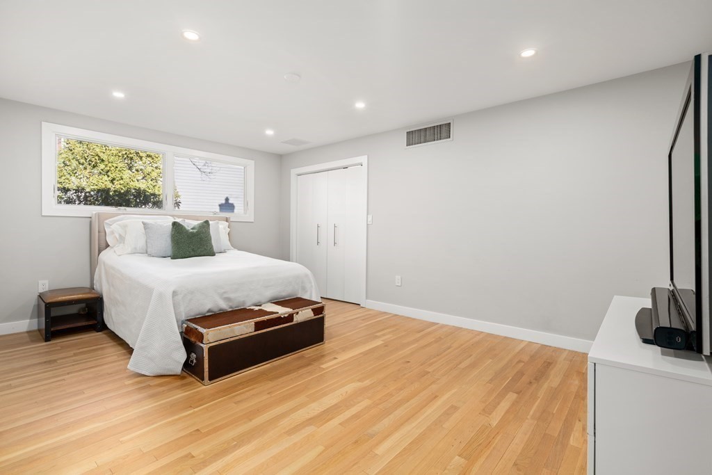 9 Newbrook Circle Newton, MA 02467 - Photo 20 of 28 a bedroom with a bed and a flat screen tv