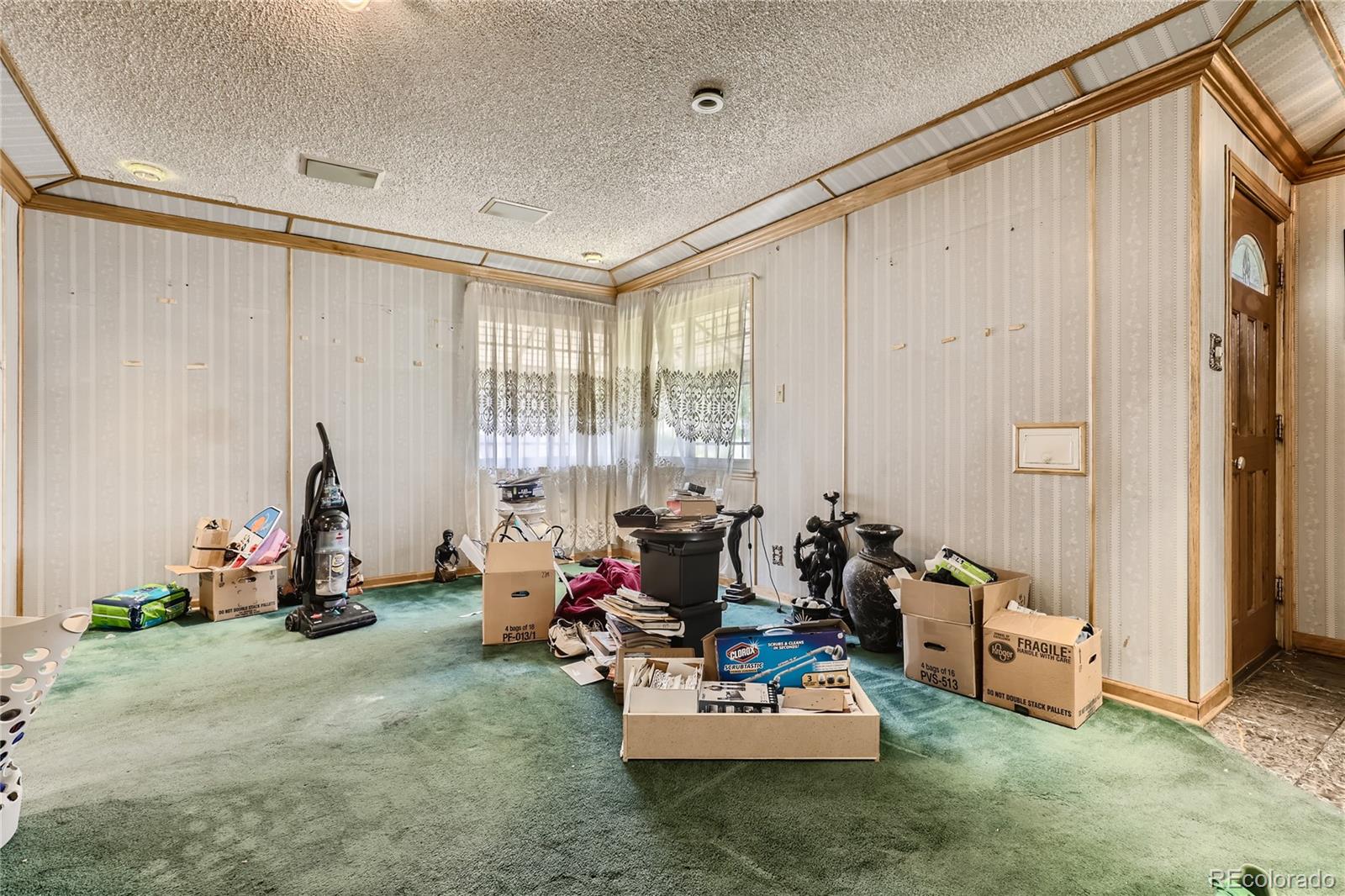 3550 Eudora Street Denver, CO 80207 - Photo 2 of 19 a living room with furniture and floor to ceiling window