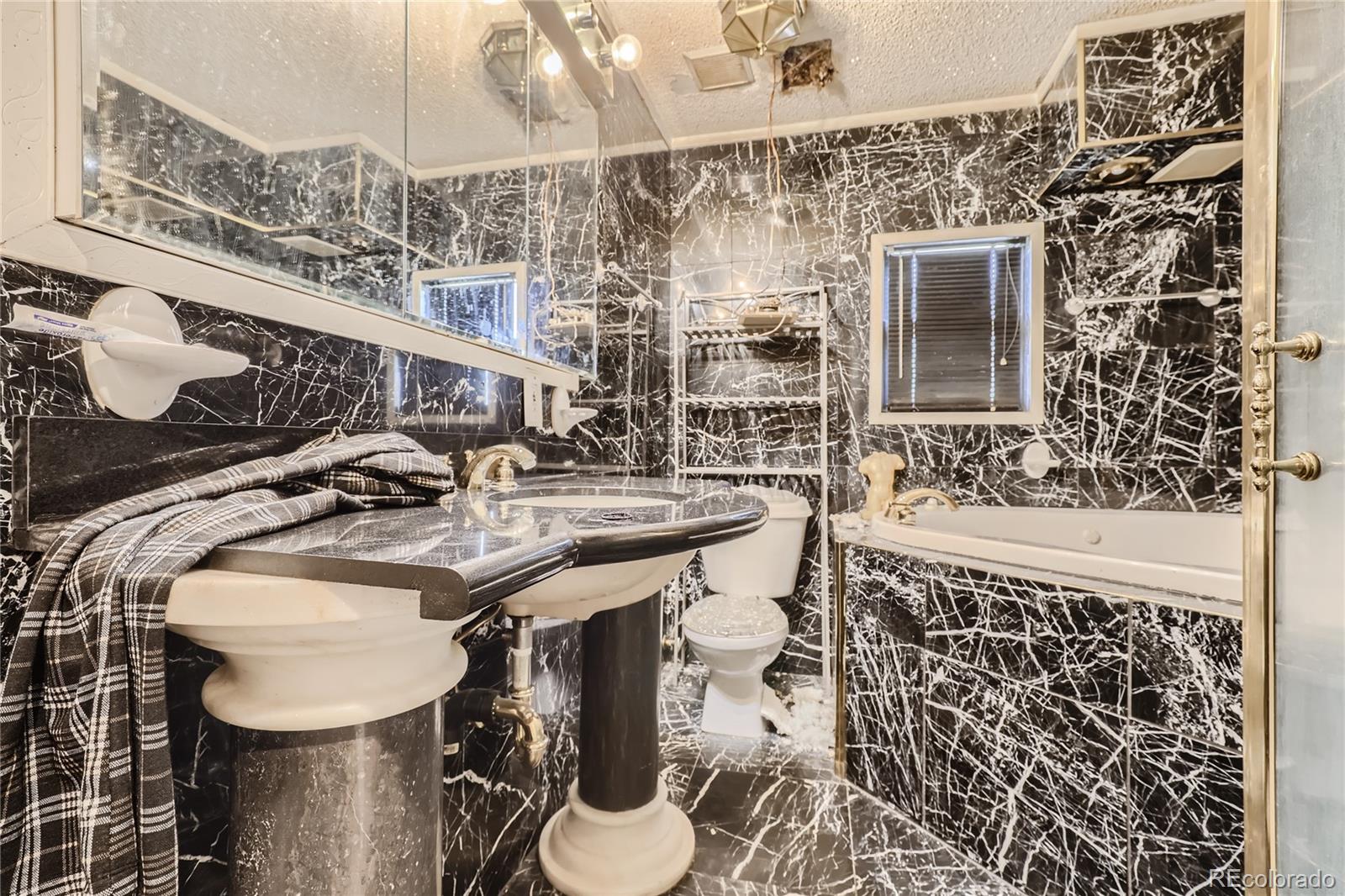 3550 Eudora Street Denver, CO 80207 - Photo 8 of 19 a bathroom with a sink a toilet and shower