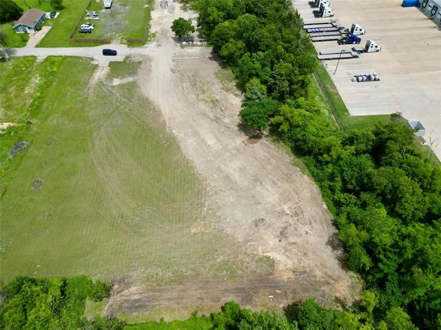 an aerial view of a residential houses with outdoor space