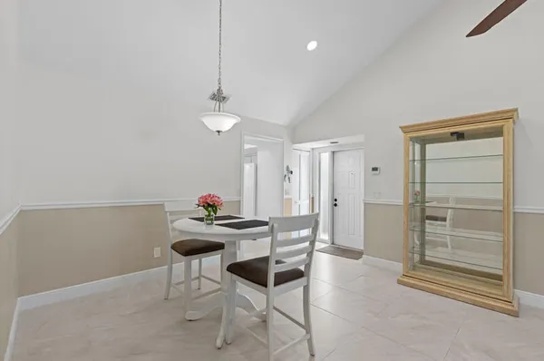 a dining room with furniture and a chandelier