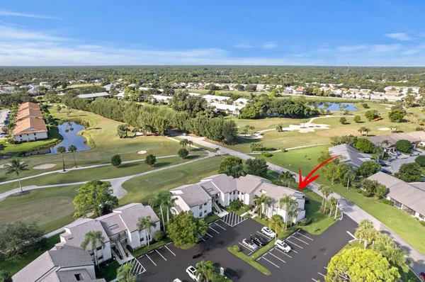 an aerial view of residential houses with outdoor space and trees