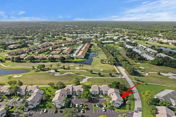 an aerial view of residential houses with outdoor space and trees