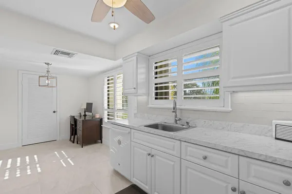 a bathroom with double sink and a window