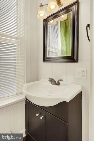a bathroom with a sink vanity and a mirror