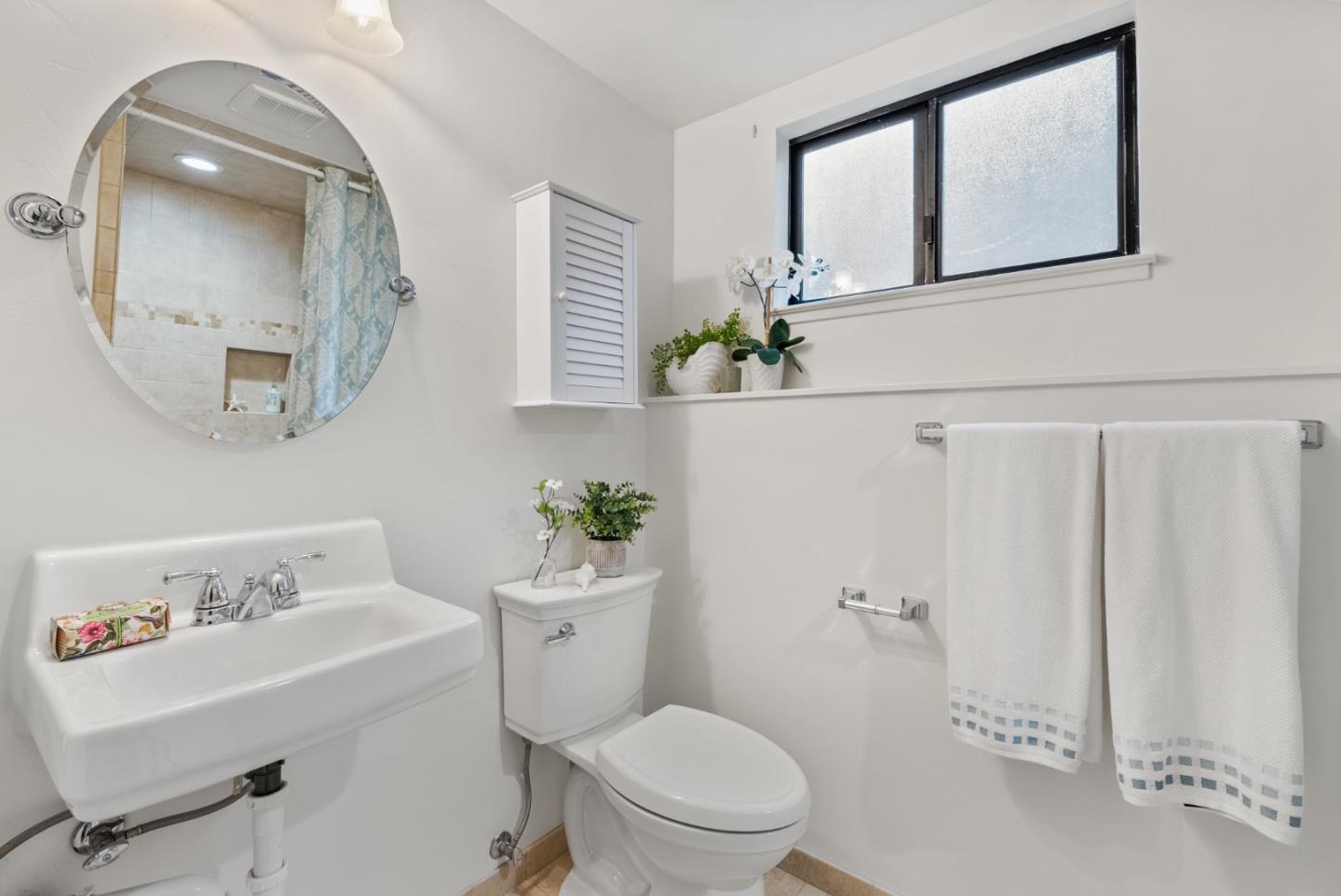 8935 Coker Road Salinas, CA 93907 - Photo 32 of 90 a white toilet sitting next to a bathroom sink