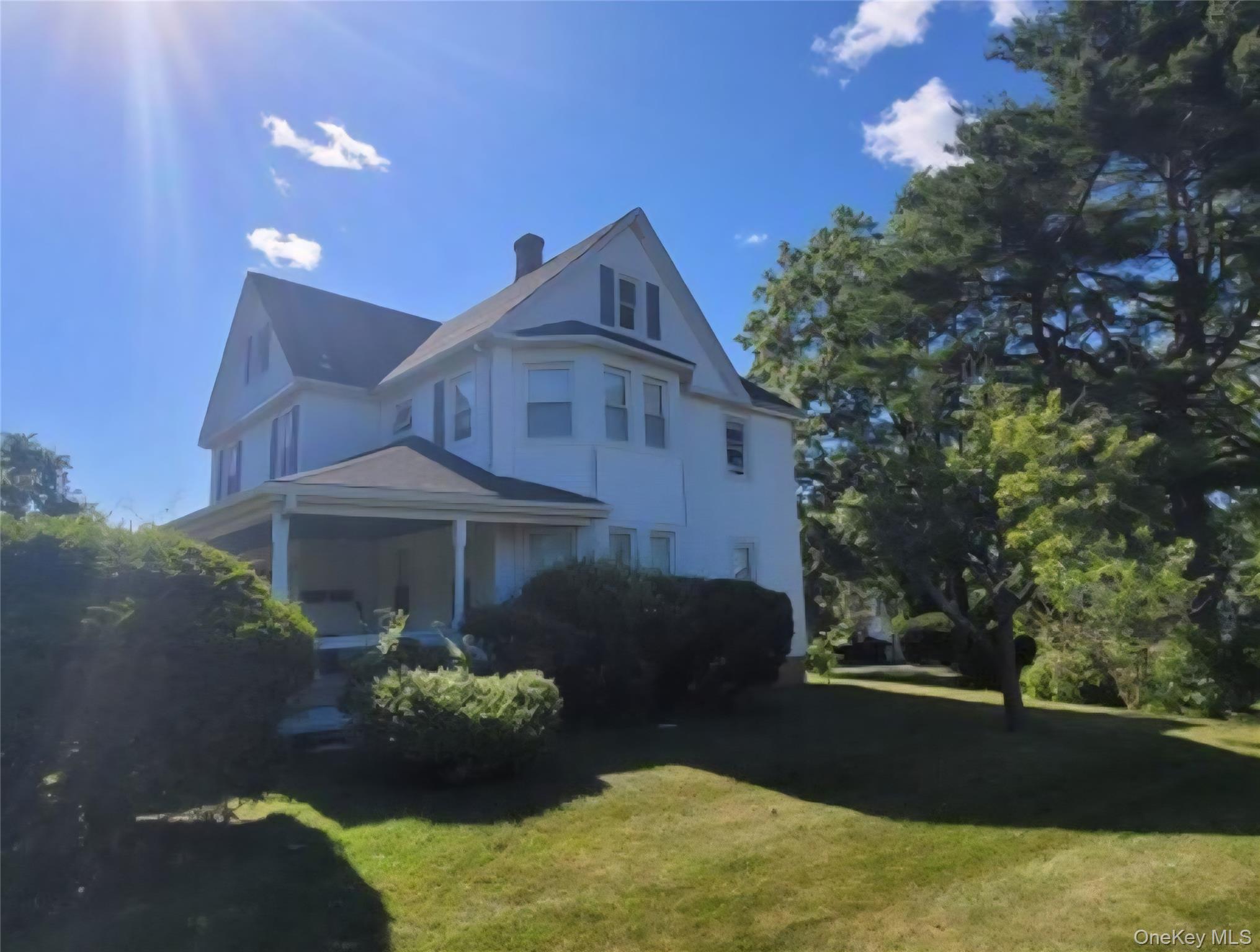 21-23 George Street Manhasset, NY 11030 - Photo 2 of 15 a front view of a house with garden