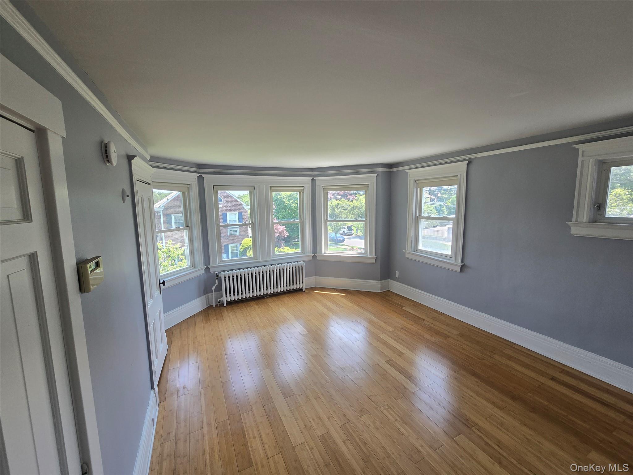 21-23 George Street Manhasset, NY 11030 - Photo 5 of 15 a view of an empty room with wooden floor and a window