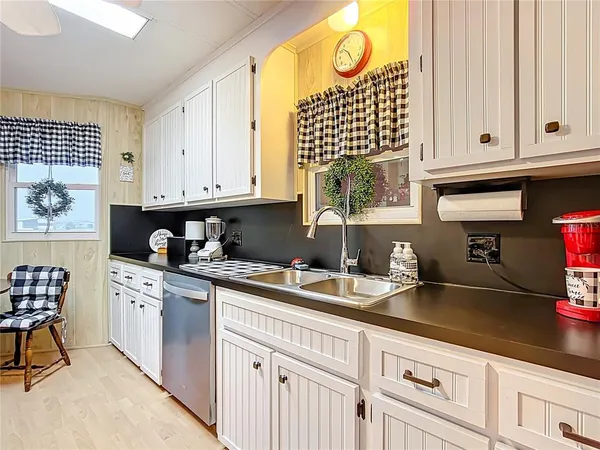 a kitchen with granite countertop a sink and cabinets