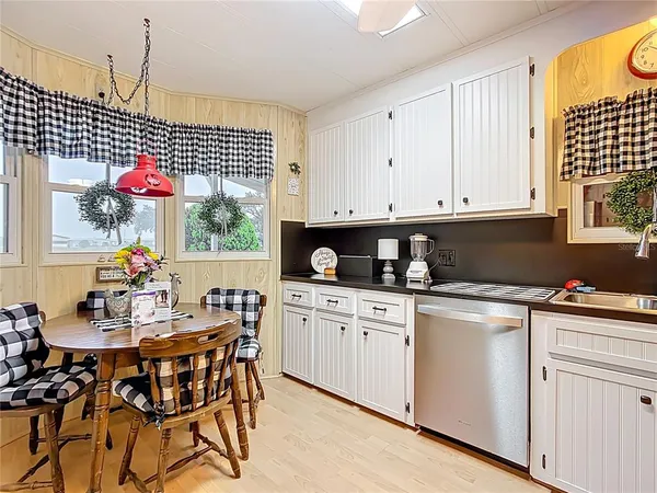 a kitchen with stainless steel appliances granite countertop a sink and cabinets