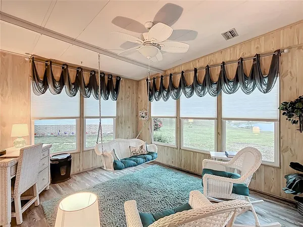 a bedroom with furniture and a large window