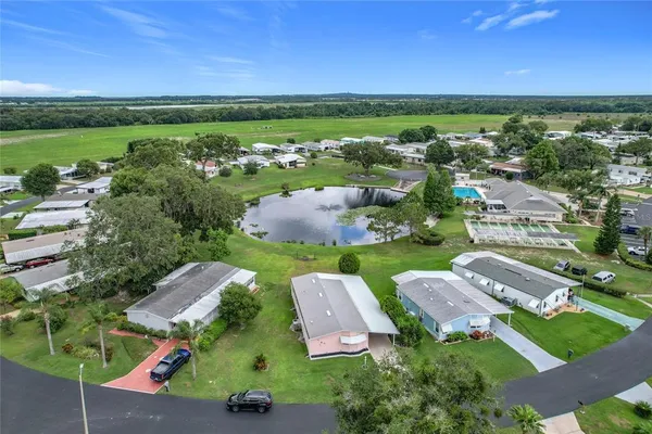 an aerial view of residential houses with outdoor space and street view