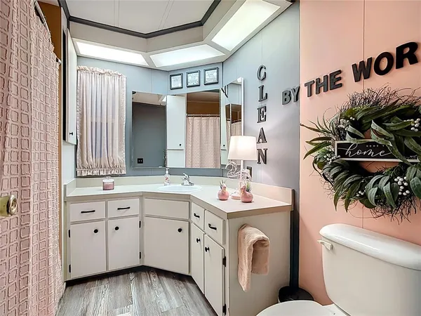 a view of bathroom with a toilet sink and mirror