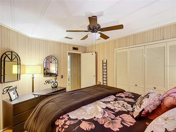 a bedroom with a bed mirror and window