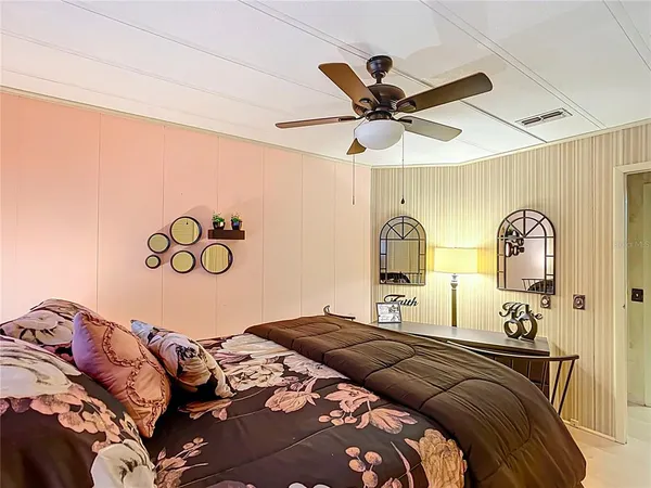 a bedroom with a bed and a painting on the wall