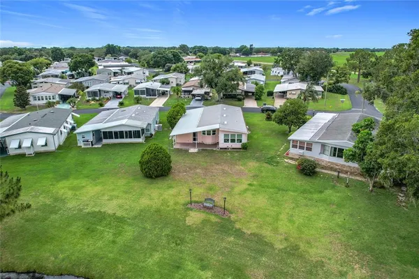 an aerial view of a house with garden space and street view