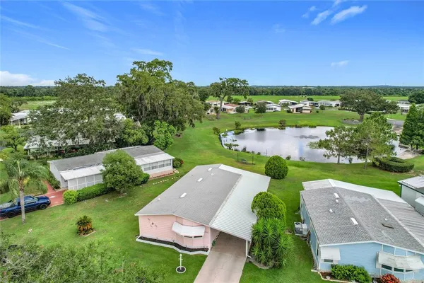 an aerial view of residential houses with outdoor space and river
