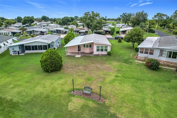 an aerial view of a house with a yard basket ball court and outdoor seating