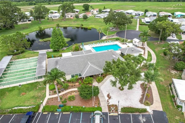 an aerial view of residential houses with outdoor space and lake view