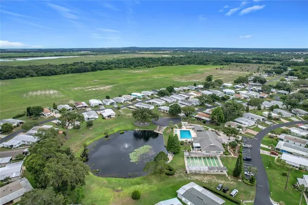 an aerial view of residential houses with outdoor space and river