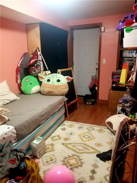 269 55th Street Brooklyn, NY 11220 - Photo 6 of 27 a room with gym equipment and a wooden floor