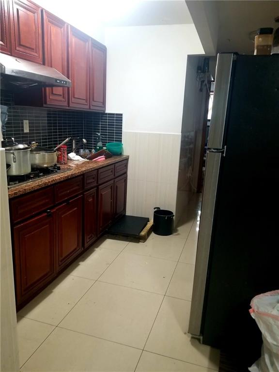 269 55th Street Brooklyn, NY 11220 - Photo 7 of 27 a kitchen with a sink and cabinets
