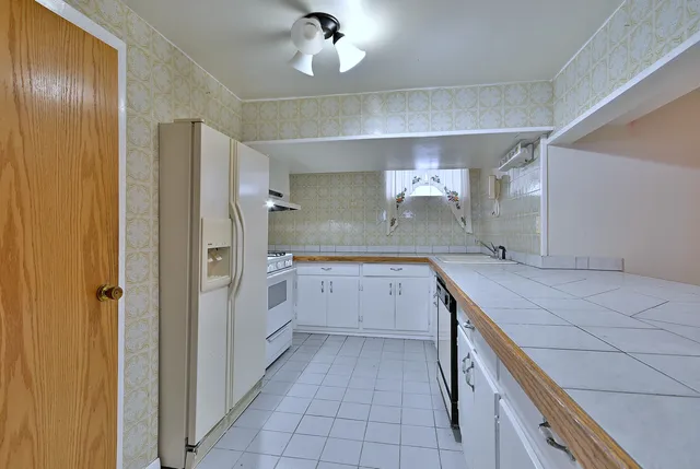 a kitchen with a sink and refrigerator