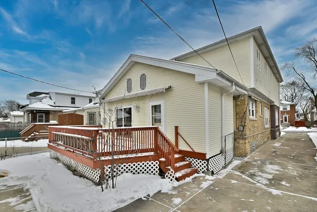 a view of a house with wooden deck