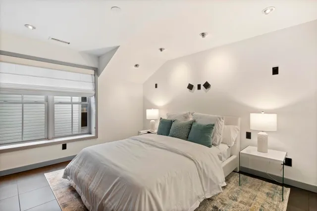 a bedroom with a large bed and a window