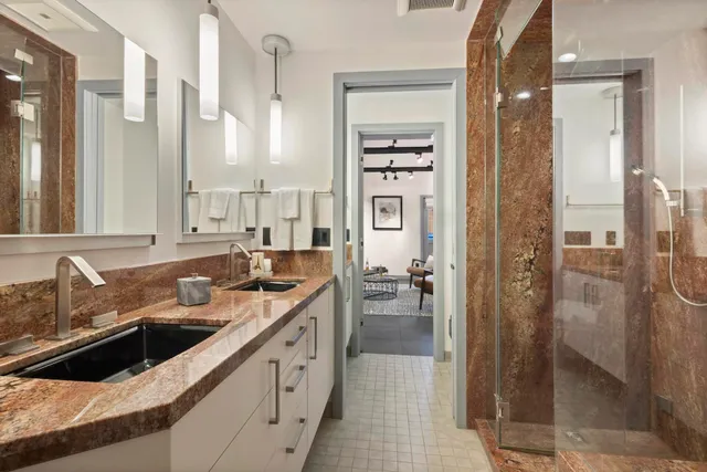 a bathroom with a sink a toilet and shower