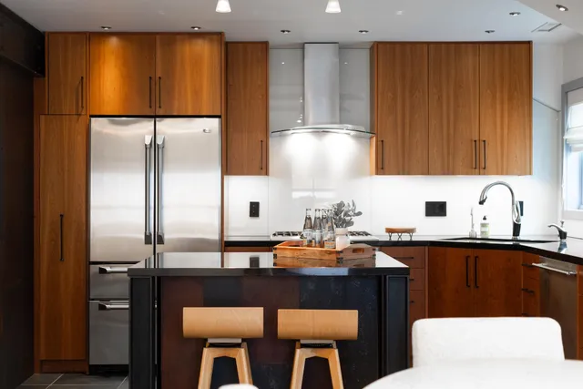 a kitchen with a sink refrigerator and cabinets
