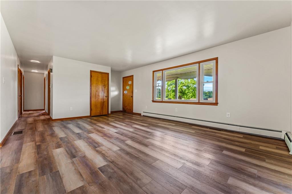 3205 Eastbrook Volant Road Volant, PA 16156 - Photo 13 of 29 a view of an empty room with wooden floor and a window