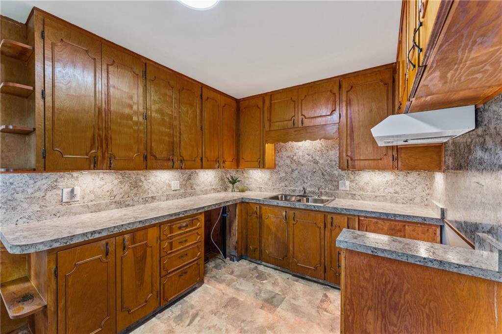 3205 Eastbrook Volant Road Volant, PA 16156 - Photo 19 of 29 a kitchen with stainless steel appliances granite countertop a sink a stove and a wooden cabinets