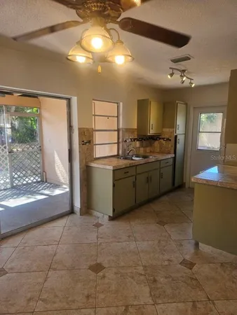 a kitchen with stainless steel appliances granite countertop a sink and a refrigerator