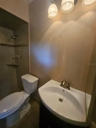 a bathroom with a toilet sink and shower