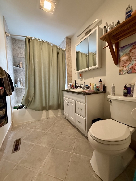 253 Brown Street, Unit 1 Waltham, MA 02453 - Photo 14 of 17 a bathroom with a toilet sink and mirror
