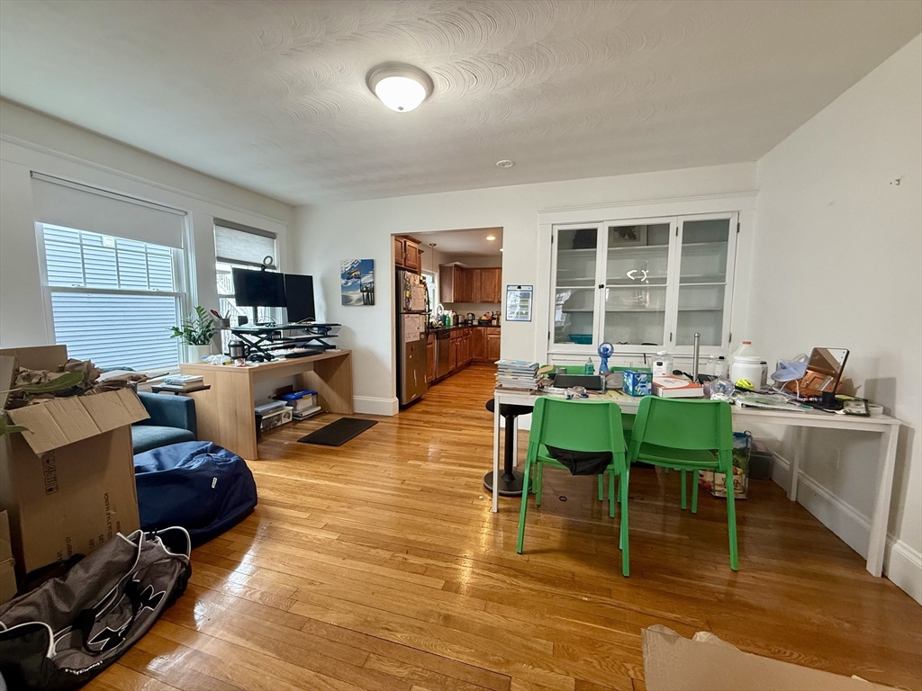 253 Brown Street, Unit 1 Waltham, MA 02453 - Photo 5 of 17 a living room with furniture dining table and a wooden floor