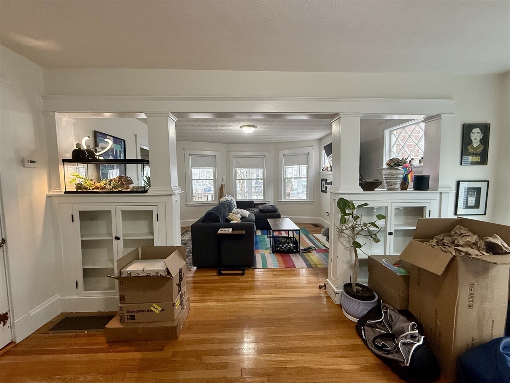 253 Brown Street, Unit 1 Waltham, MA 02453 - Photo 6 of 17 a living room with furniture and a wooden floor