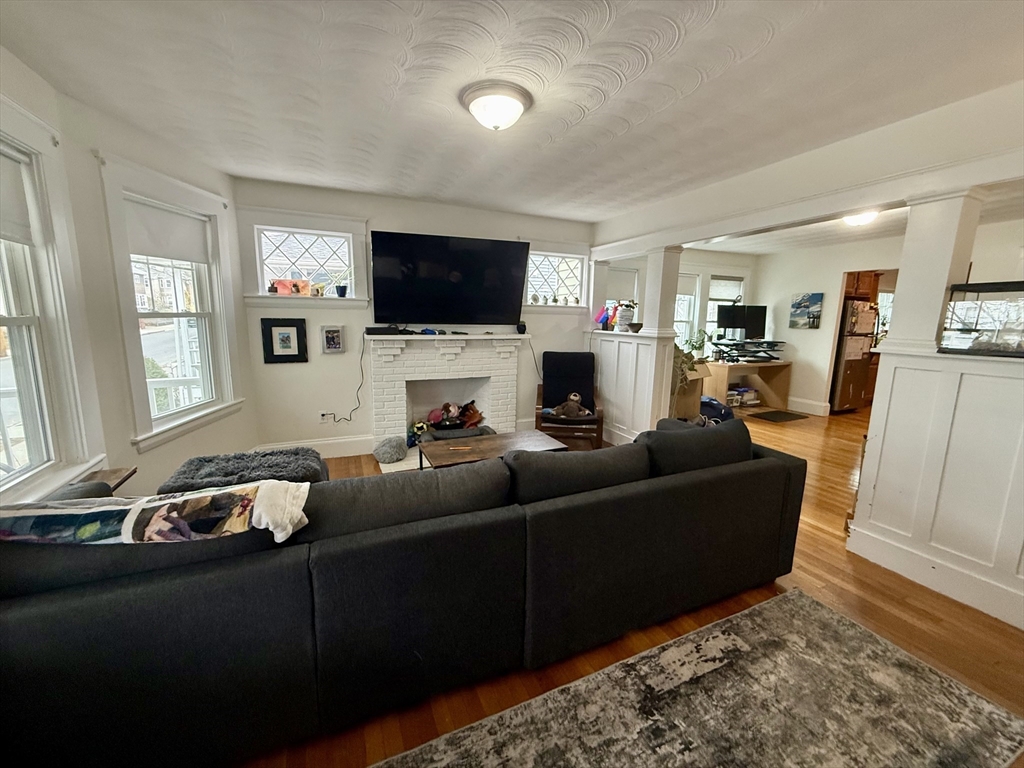 253 Brown Street, Unit 1 Waltham, MA 02453 - Photo 8 of 17 a living room with furniture and a flat screen tv